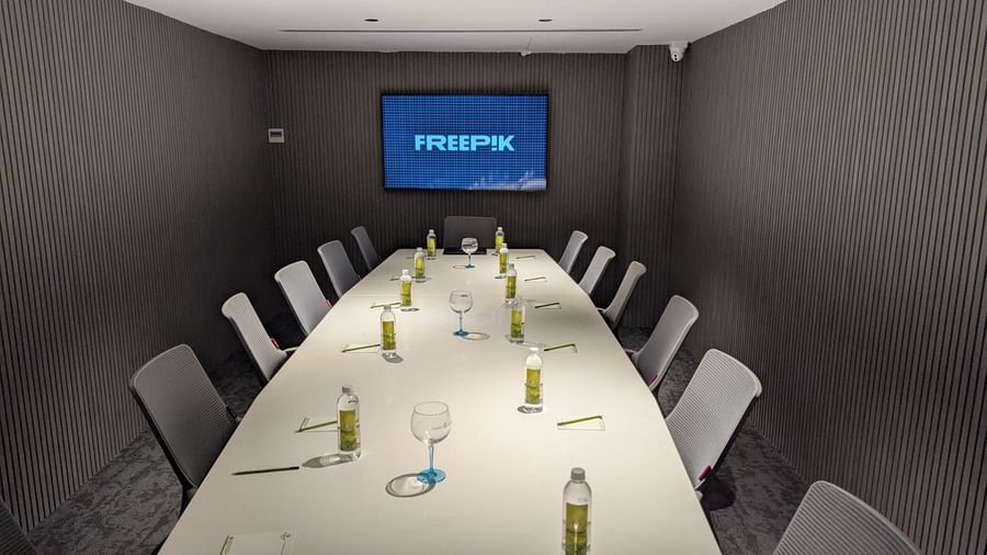 Boardroom with chairs aligned around a table and screen at Fressotel, Kanakapura Road, Bangalore.
