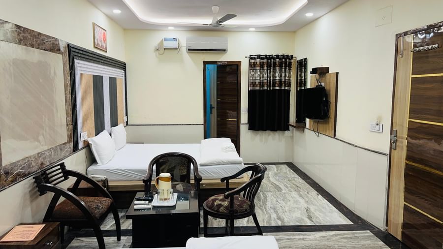 A well-appointed hotel room featuring a bed, a sofa, and a television, ensuring a comfortable stay. | Family Room | Hotel City Palace DX