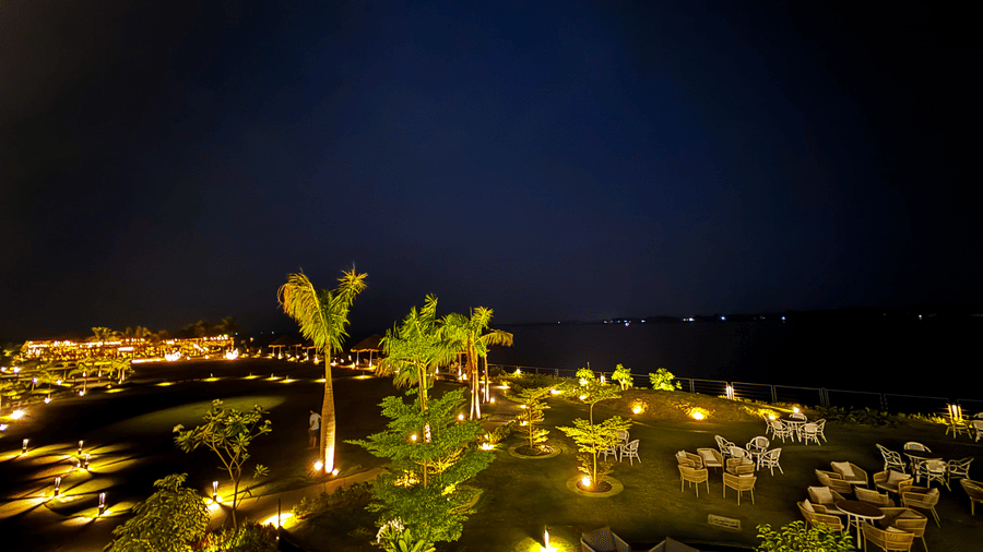 Elevated view of the lawn of Hotel Sonar Bangla, Kolaghat, seen with trees and place lightings.