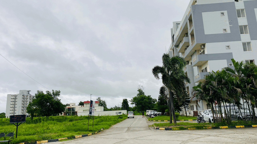 Paved driveway with landscaped greenery and the facade of Livbox, Rudrapur.