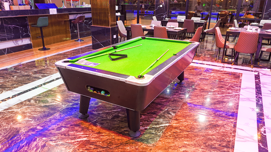 Interior view of a lounge area with a small pool table - Luffu Club