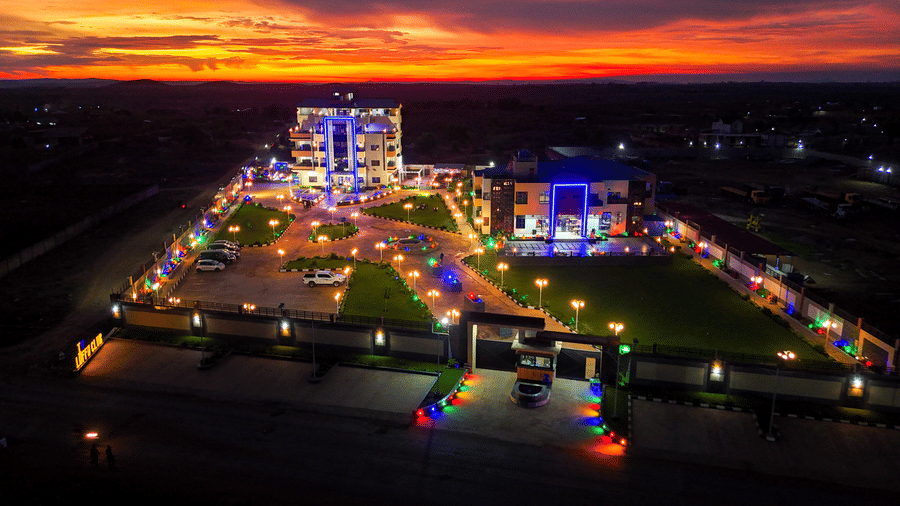 Exterior view of a building and grounds illuminated under bright orange sky - Luffu Club