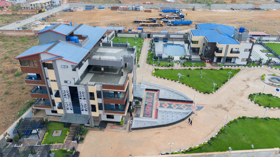 Aerial view of a modern two-storey building with a landscaped yard and pool area - Luffu Club