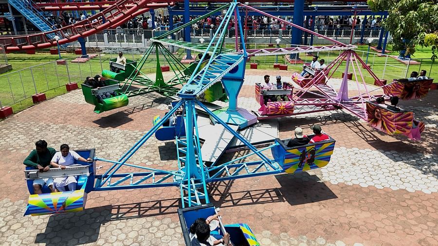 Twister ride at MGM Dizzee World featuring open rides with seats for two rotating up and down.