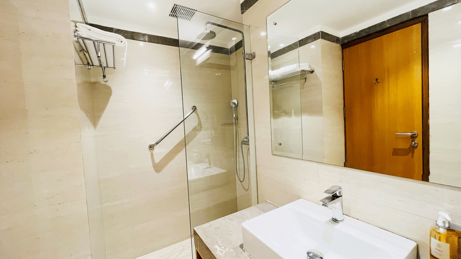 Modern bathroom at Nemesia featuring a walk-in shower, a vanity sink.