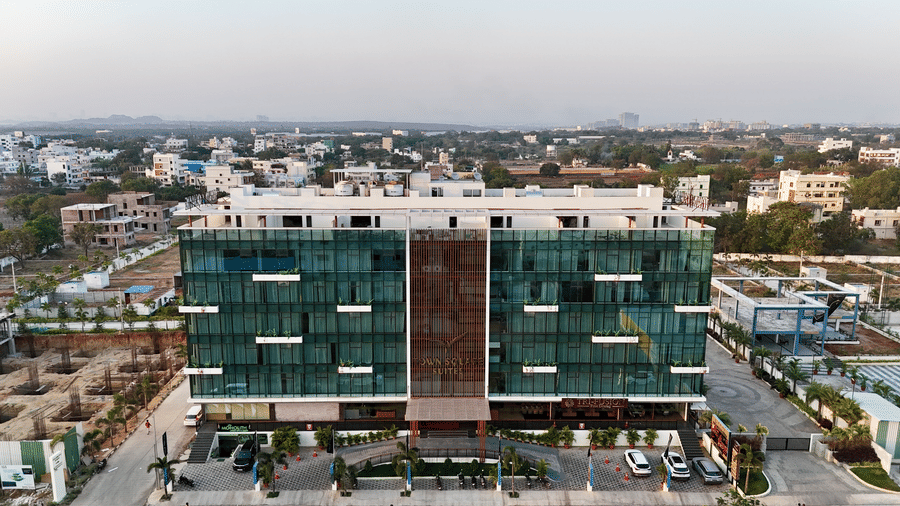 Aerial view of Town Square Suites showing surrounding cityscape and modern building exterior.