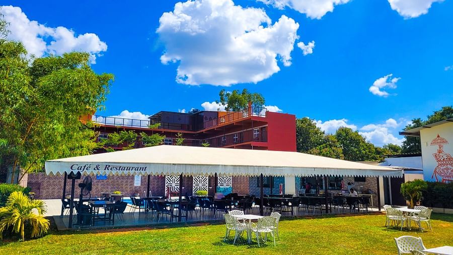 Wide view of a covered restaurant during the day | Vistar Resort, Bengaluru