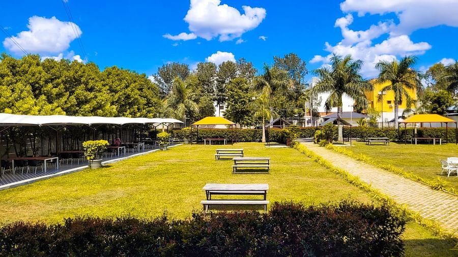 Wide view of lush green garden during the day | Vistar Resort, Bengaluru