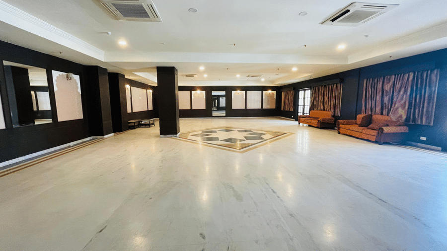 Wide view of Raj Samelan Hall at Shri Vallabh Vilas Lords Plaza Nathdwara featuring clean titled floor, with minimalistic furniture.