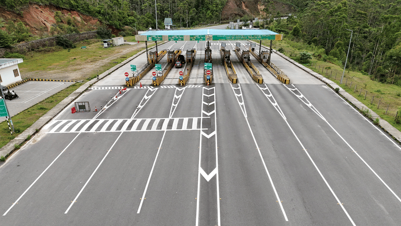 Aerial view of a multi-lane highway toll plaza on a road trip.