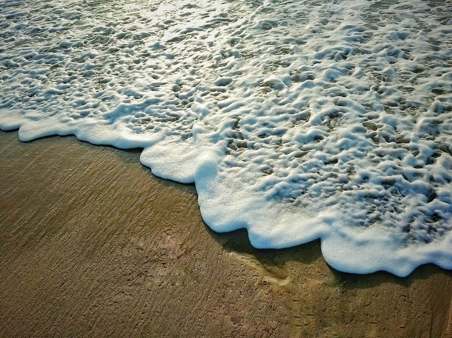 a close up image of waves crashing against the shore