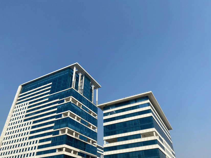 2 modern commercial buildings with distinctive horizontal white stripes and blue glass facades.