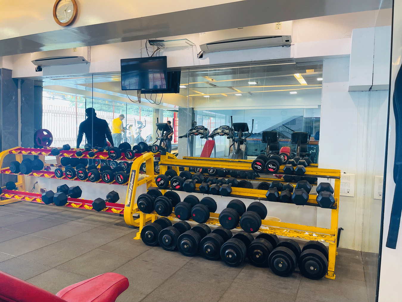 Dumbells racked up inside the gym room at Home2 Renaissance Club Hotel