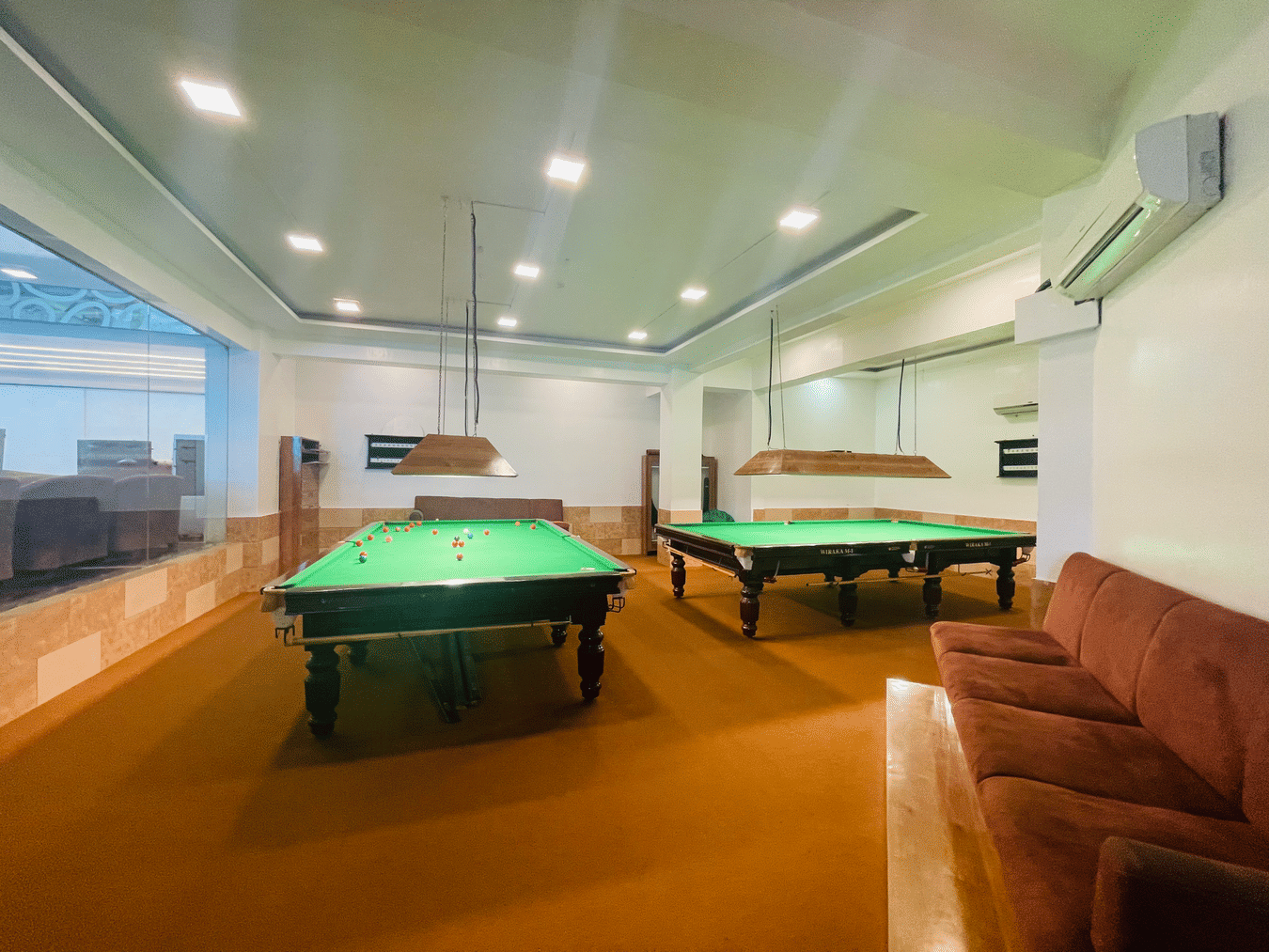 Pool and snooker table next to a sofa at Home2 Renaissance Club Hotel