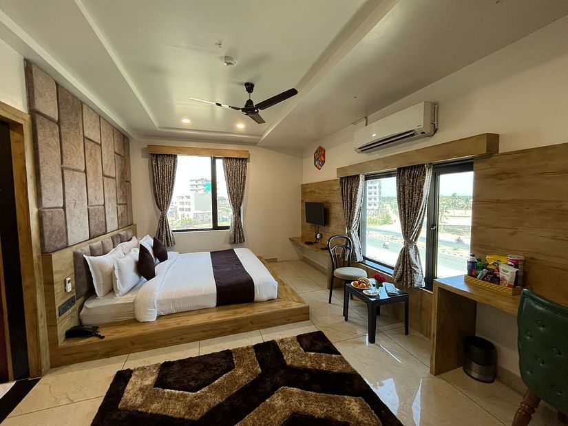 Side view of the premier room with a king-sized cosy bed at Clarks Collection, Somnath