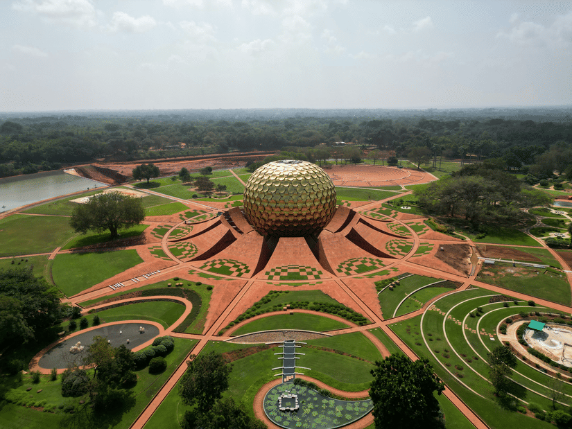 Aerial view of Auroville with the golden dome glowing in the sunlight, one of the places to visit near Pondicherry