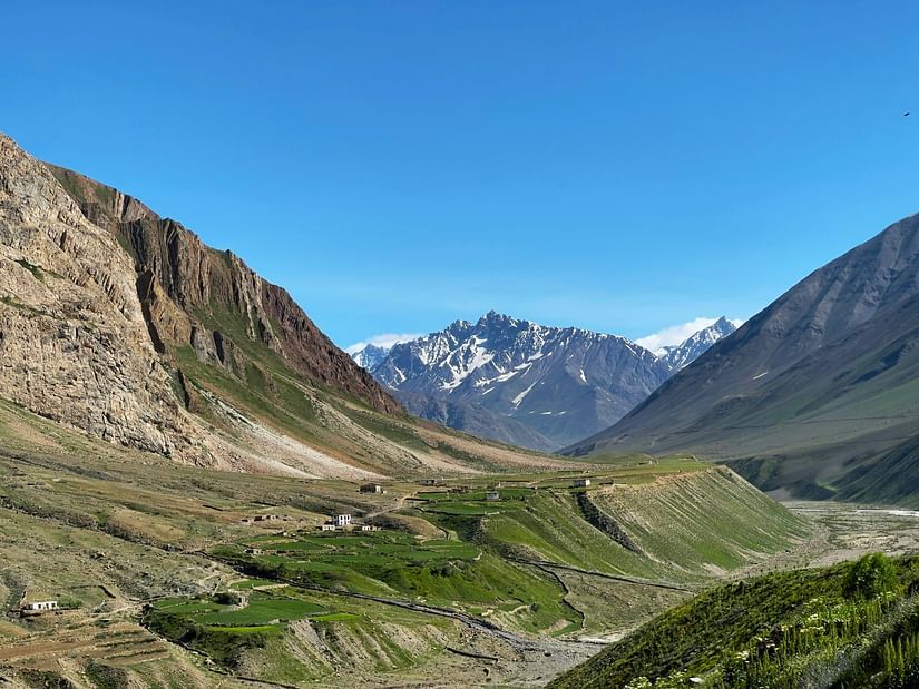 An overview of Pin Valley National Park with green valleys and snow capped mountains in view.