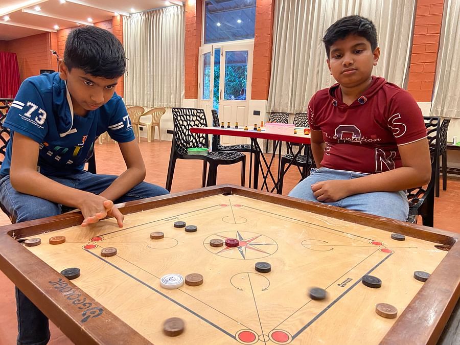 kids playing carrom in the game room  - Ibex River Resort, Pollachi