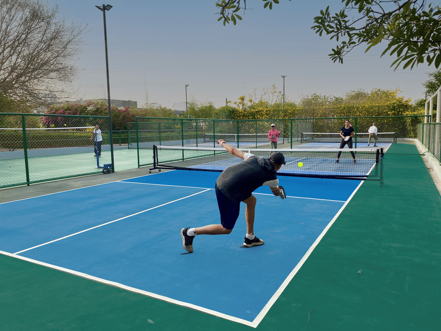 Guests playing pickleball on the pickleball court inside karma lakelands.