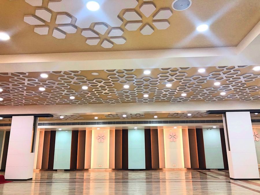an empty Banquet Hall in Tirupati with many lights switched on - Raj Park Hotel, Tirupati