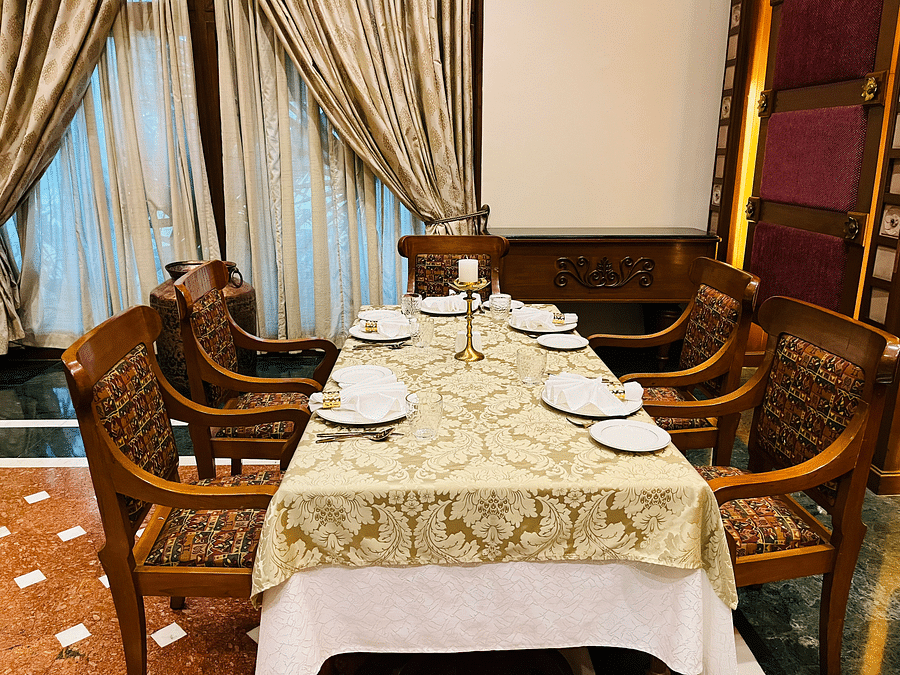 Close-up of the Kesar table setup featuring an elegant plate, comfy chairs, and a beautifully arranged table.
