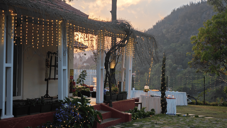 Outdoor wedding reception area at dusk with string lights and a covered porch in Coonoor - Ibex Resort, Coonoor (Leewood).