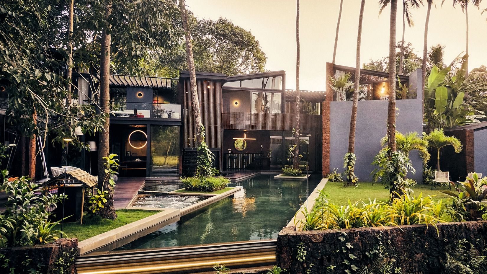 Image of Villa in Palms by V Escapes showing a lush lounging area with plants and pool