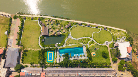Aerial view of Hotel Sonar Bangla, Kolaghat, showcasing its riverside location, swimming pool, and beautifully landscaped gardens.