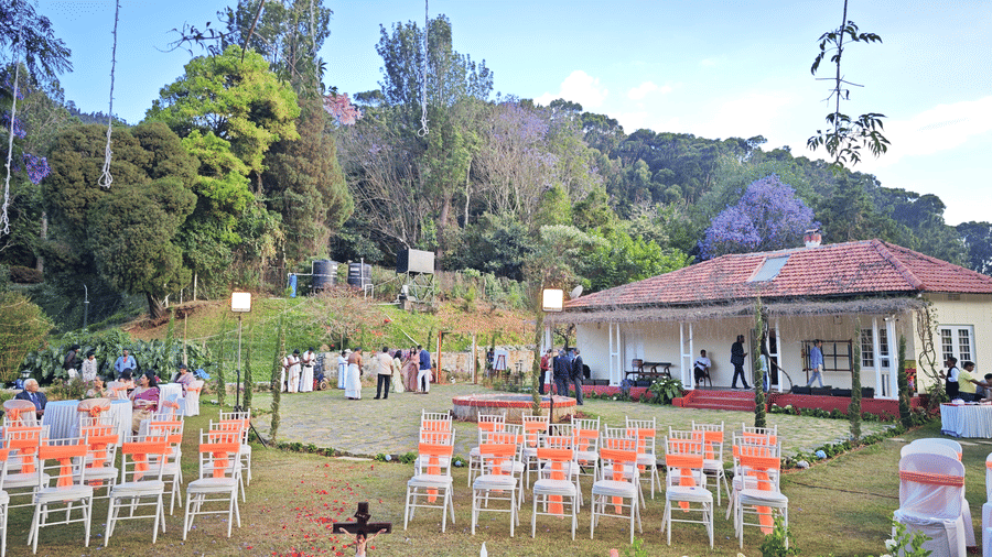 Wedding setup in Coonoor with rows of chairs and a central water feature under a tree adorned with purple flowers - Ibex Resort, Coonoor (Leewood).