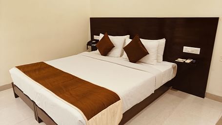 Neat single-bed room with minimalist decor at Hotel Alps Residency, Krishnagiri.