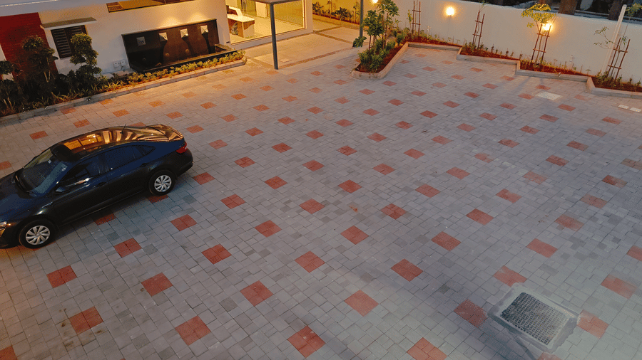 An overhead view of the paved hotel forecourt at Bliss Giriya By Bergamont Tiruvannamalai with parked vehicles.