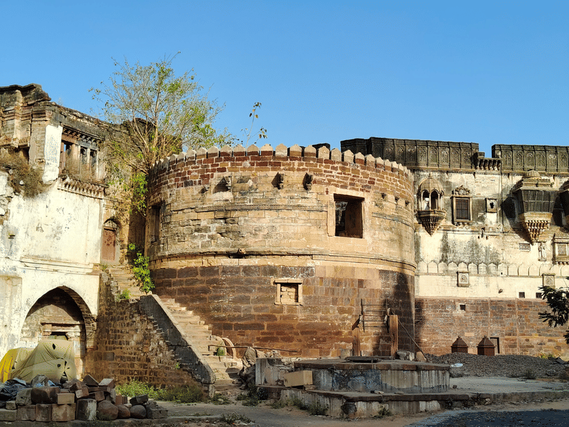 Exterior view of a historic riverside fort featuring stone walls, arched entrances, and traditional architectural details.