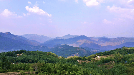 Layered hills and scenic landscape view of Yercaud, with the sky painted with pinkish hues.