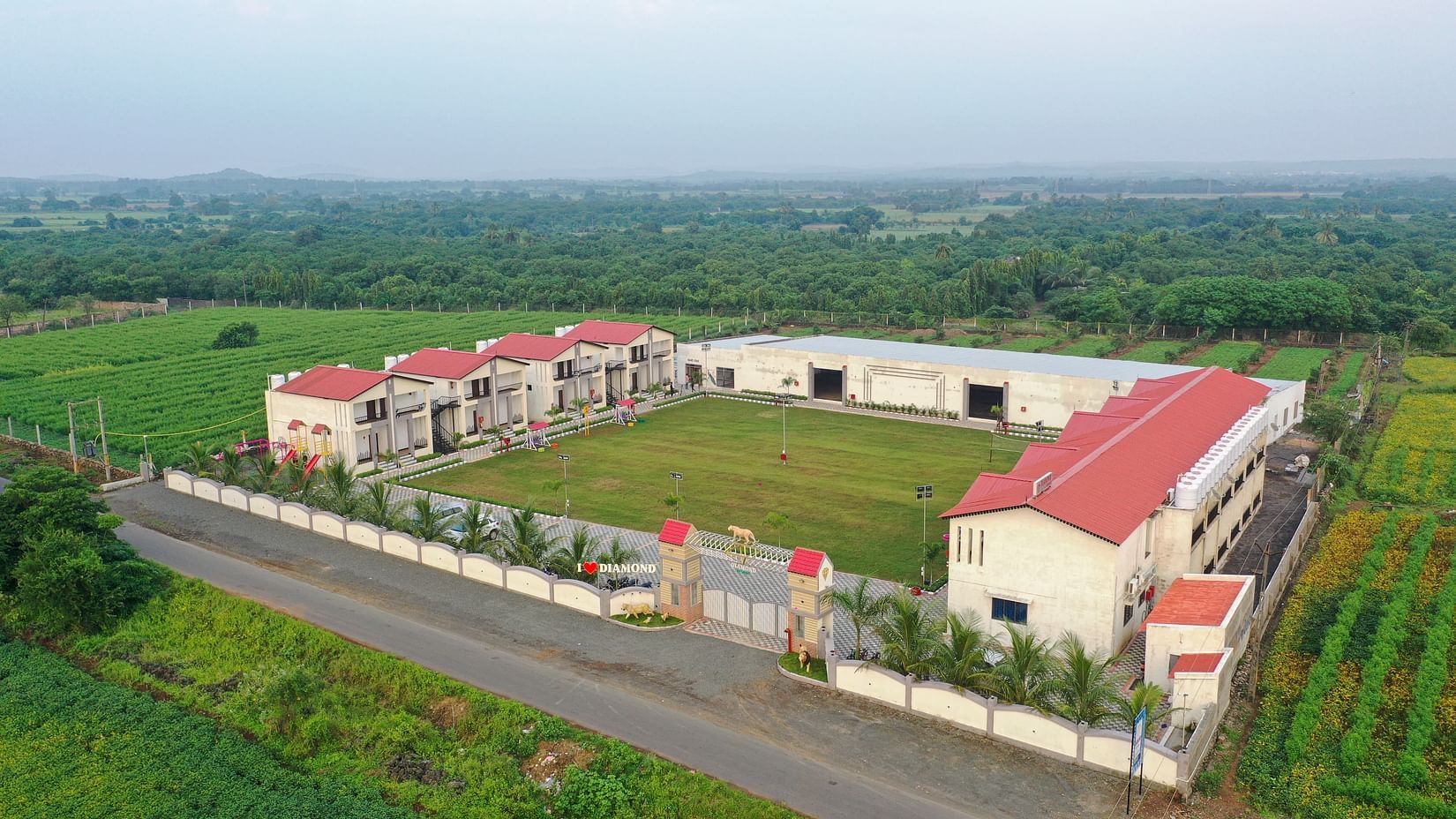 A bird's eye view of the resort with a one way road in front of the premises of the resort - VITS Select Diamond Resort, Sasan Gir