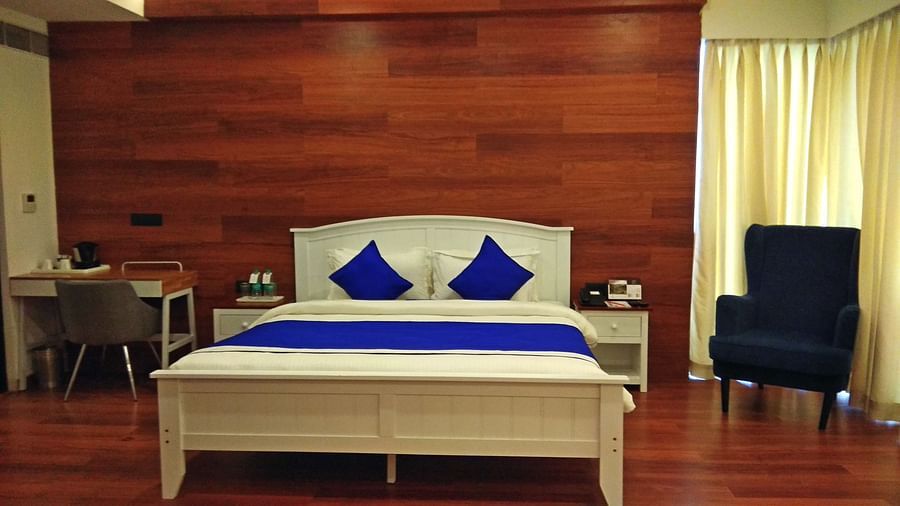 a bed with blue pillows and duvets