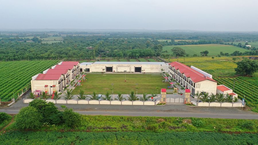 A bird's eye view of the facade of the resort nestled amidst lush green farms - VITS Select Diamond Resort, Sasan Gir