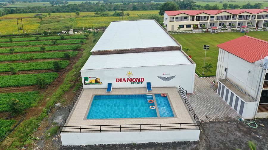 Aerial view of the resort featuring multiple swimming pools, surrounded by greenery and well-maintained grounds - VITS Select Diamond Resort, Sasan Gir