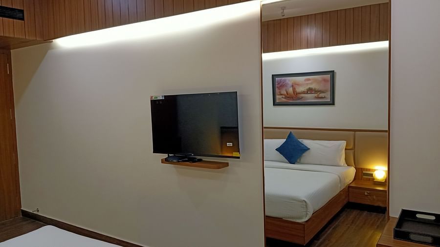 LCD TV mounted on the wall of the Executive TV beside a large looking mirror at TGI Felicity, Bangalore