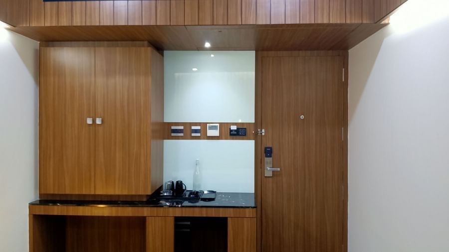 Wardrobe with with wall sockets and table at TGI Felicity, Bangalore