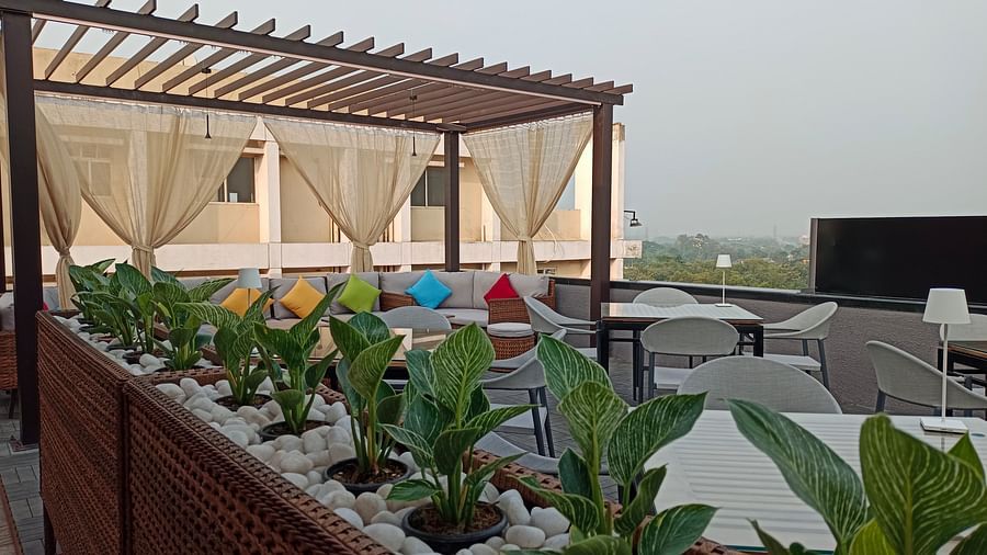 Nasha The Rooftop dining area at Wonder Country Club and Resort, Kharagpur featuring elegant seating, open-sky ambience, and side-lined greenery