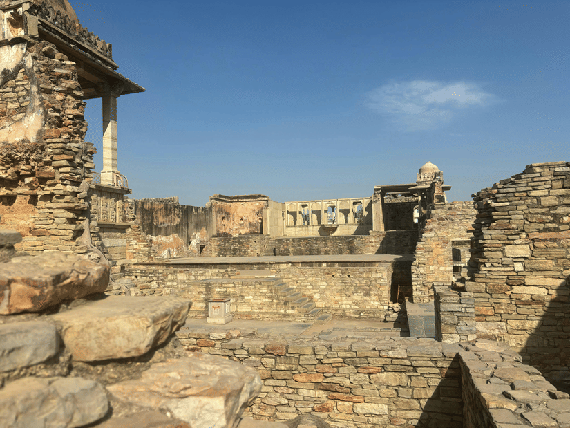 Chittorgarh Fort featuring stone courtyard with weathered walls, steps, and open sky, reflecting age-old architecture and expansive defensive design elements