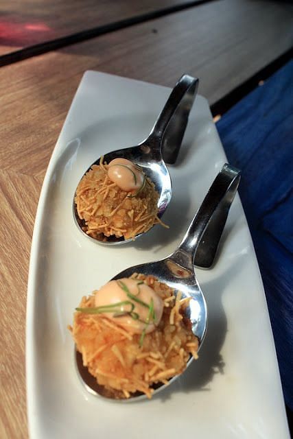 An image of a dish which is beautifully garnished and is served on a white serving plate