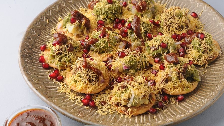 Pride Biznotel Manjusar - a plate of indian snack on a table at Cafe Pride