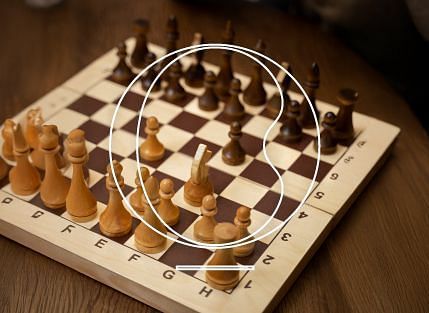 A close up shot of a chess board kept on a wooden floor - Miros Hotels