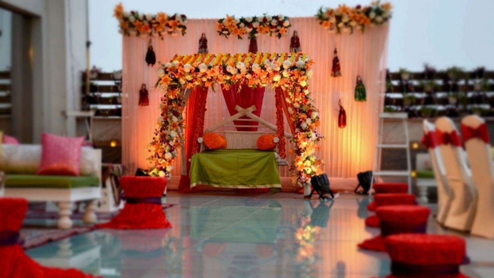 A beautiful canopy decorated with flowers and cloth with a seating area underneath at the Emerald Terrace - Ramada by Wyndham, Ghaziabad, Vasundhara