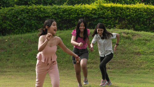 Three kids running on the lawns - Karma Lakelands.