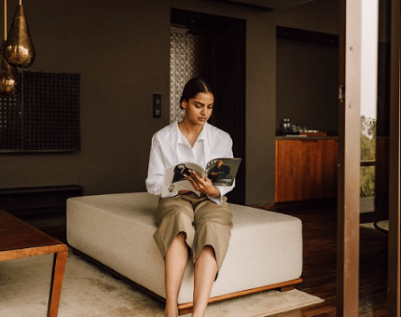 An image of a girl reading a magazine | Kavya Resort and Spa, Nagark