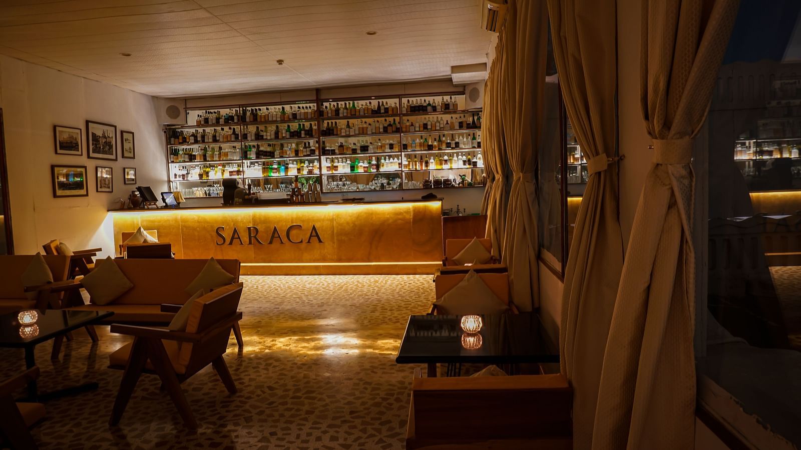 Interiors of Saraca Bar at Saraca Hotel, Lucknow with a wooden theme and a moody ambience with spot lighting