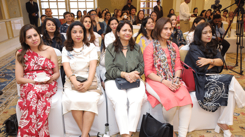 Audience seated in a luxurious conference hall during a Golf leadership event.