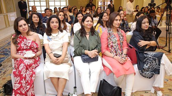 Audience seated in a luxurious conference hall during a Golf leadership event.